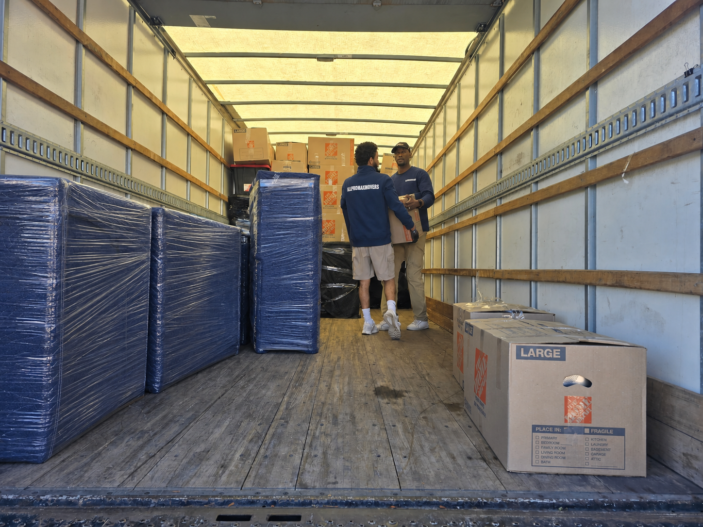 Professional movers carefully loading a protected household move