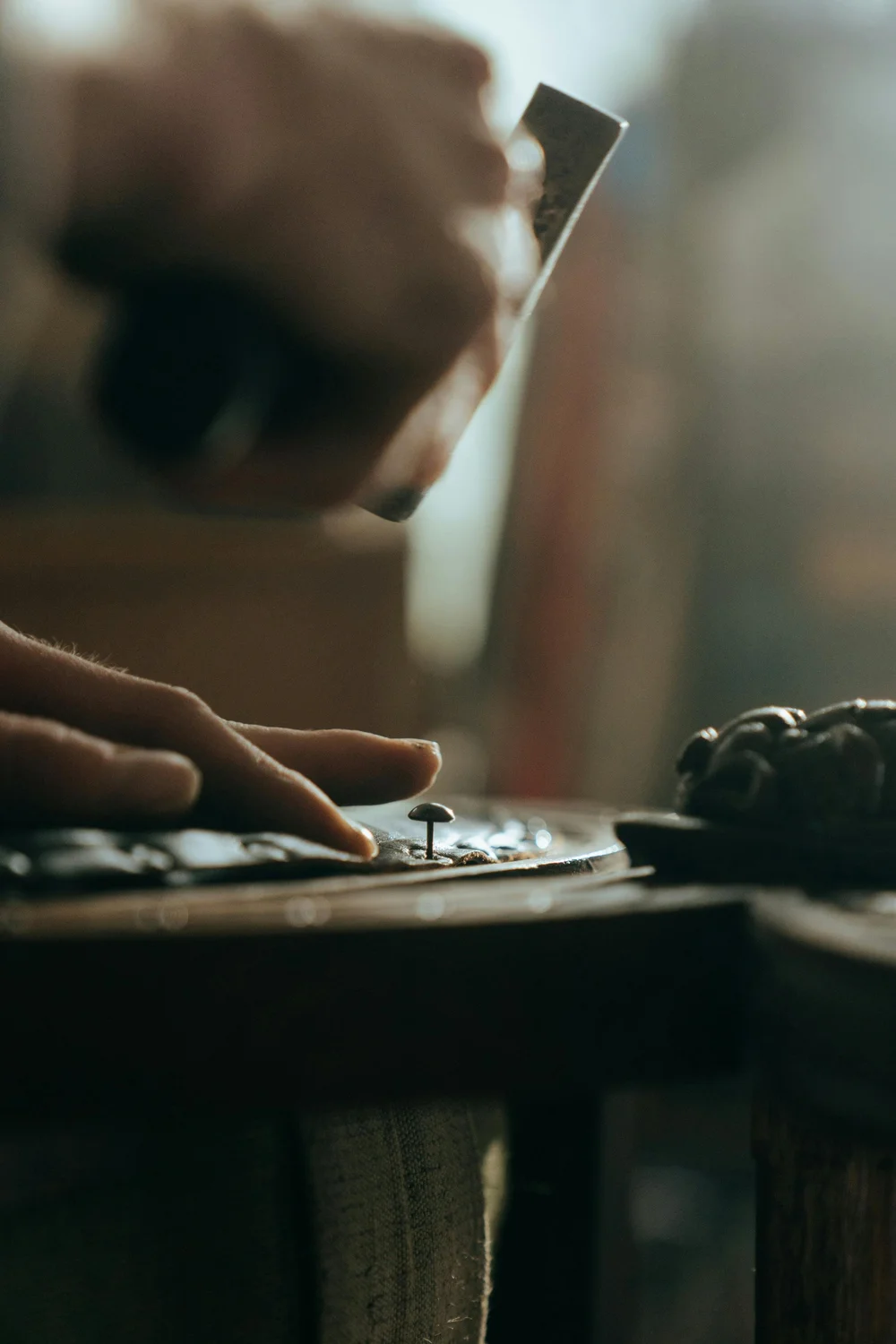 Craftsperson carefully repairing a piece of furniture
