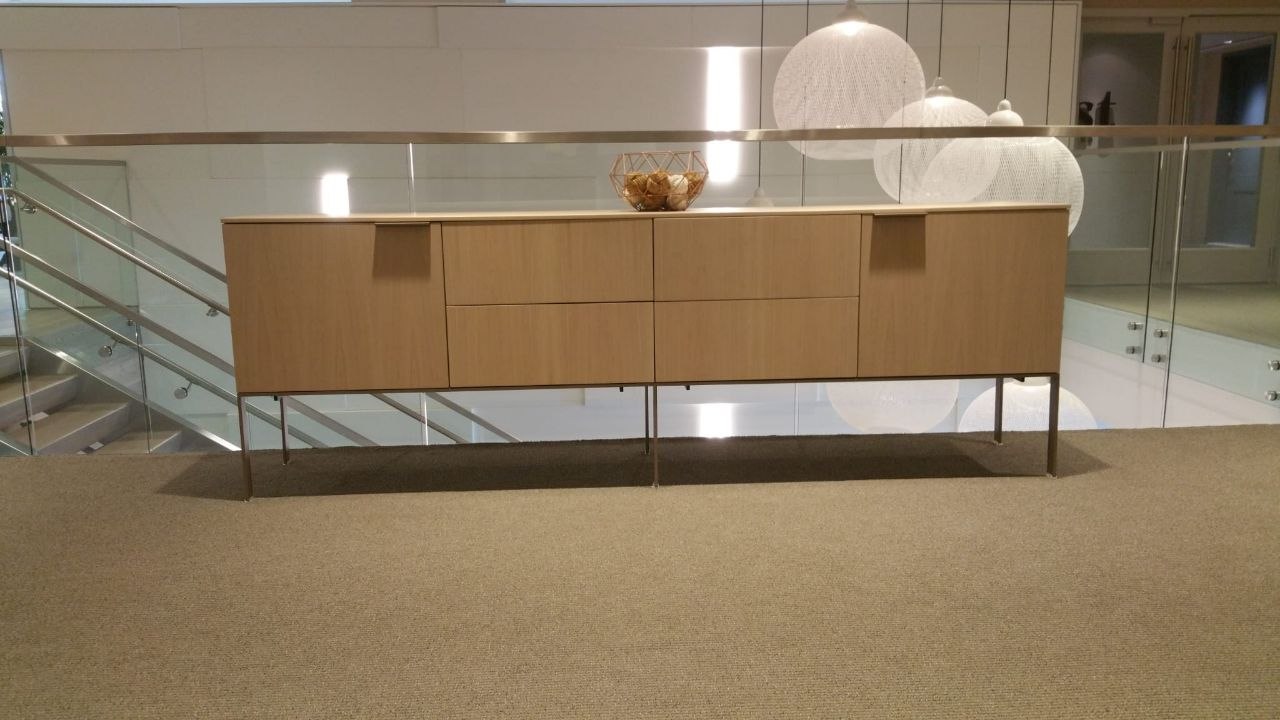 Wood sideboard positioned in a modern commercial atrium